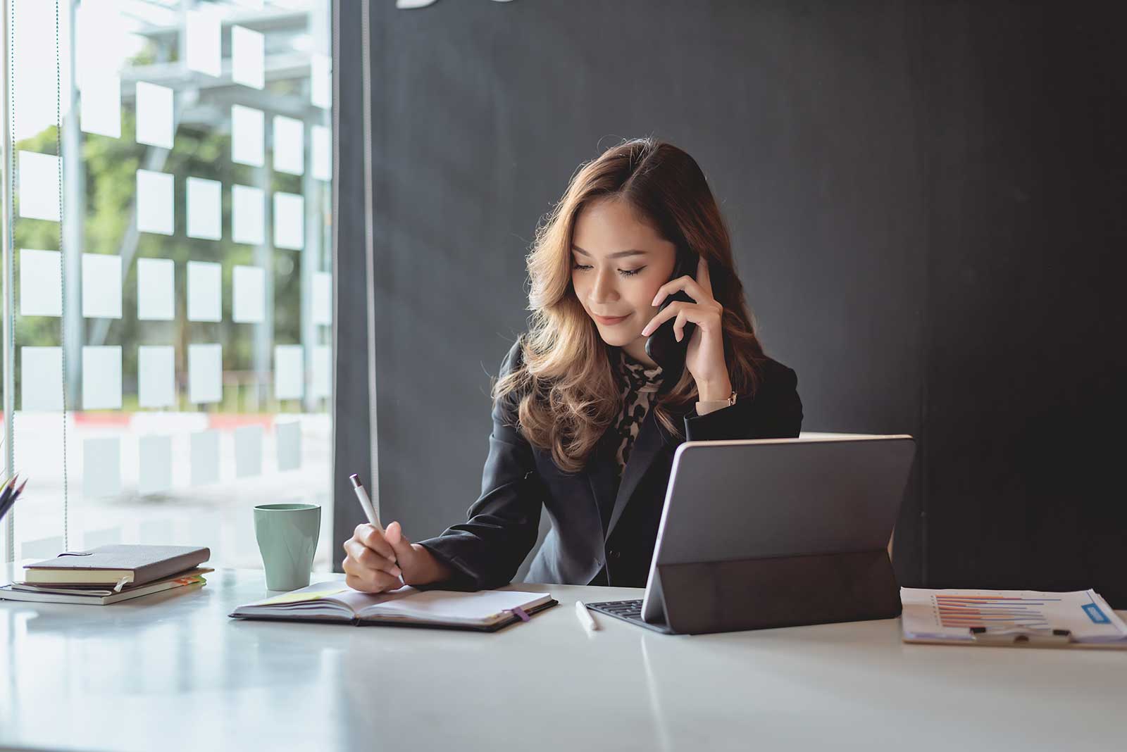 Business woman on phone getting more information about 1040 and 1099 form filing services