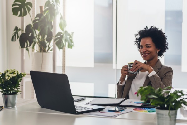 CFO sitting at her desk after acquiring payroll processing services