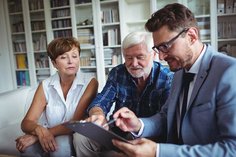 Elderly couple working with an estate planning specialist