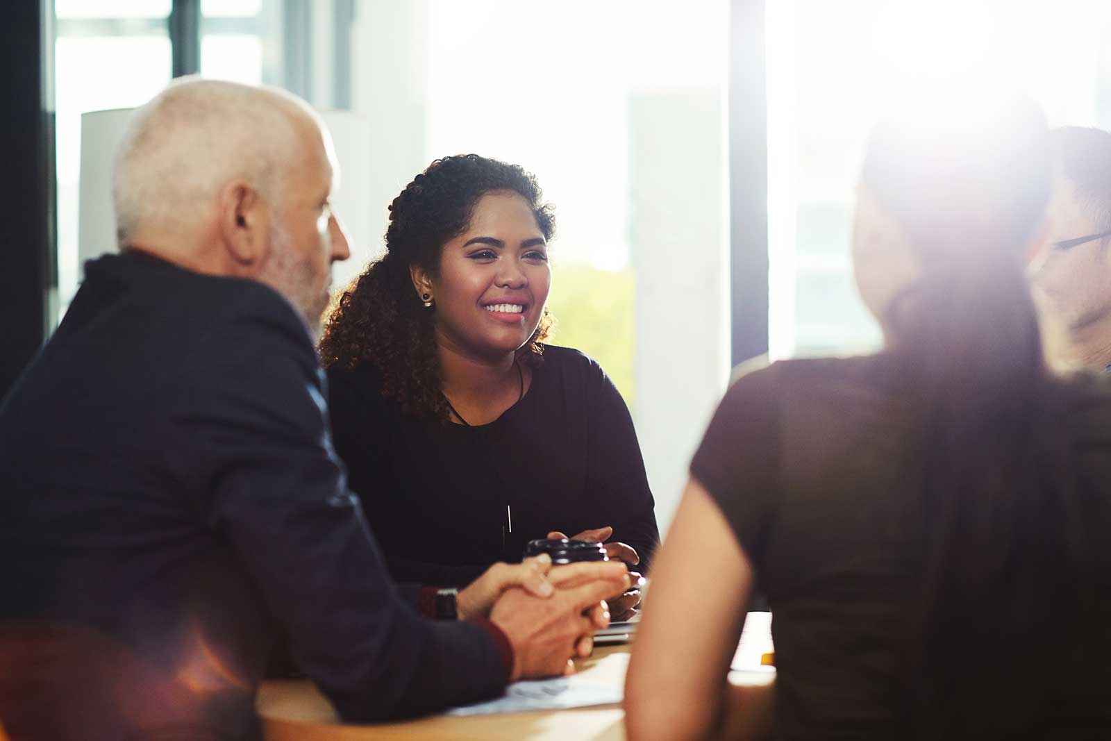 Employer meeting with employee benefits consultants about her organization's benefits plan