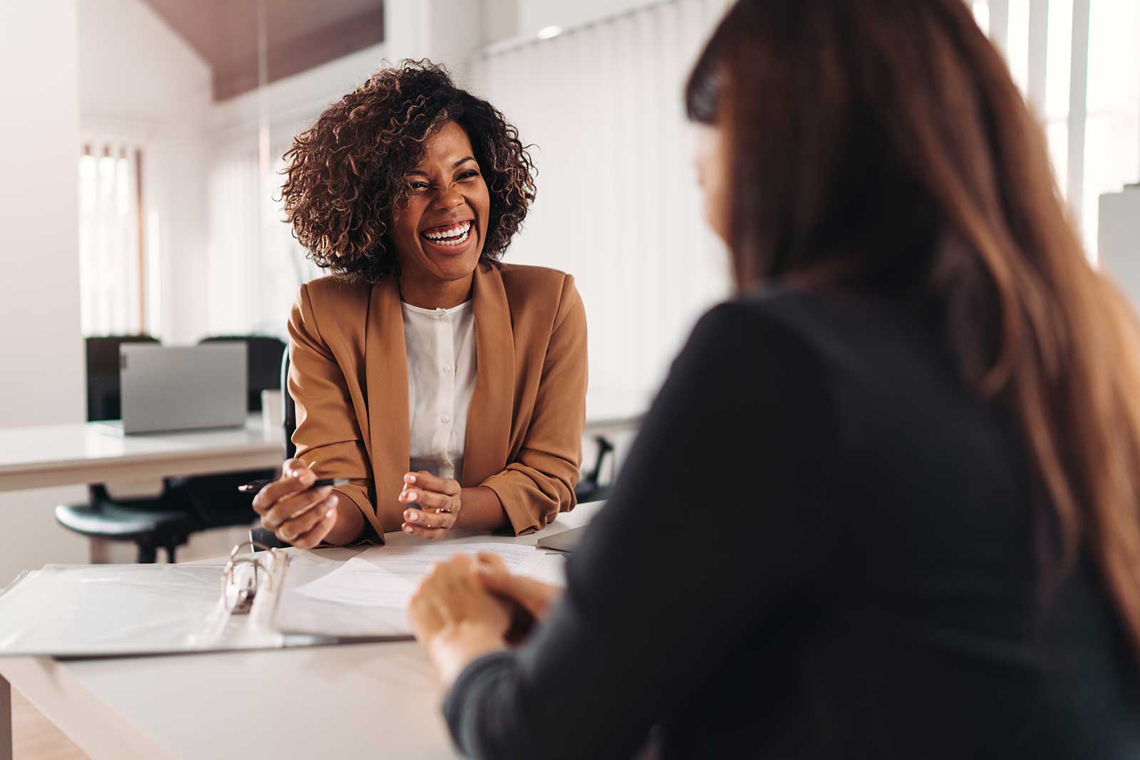 Financial advisor smiling and having fun with her client