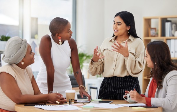 Group of employees talking about help desk services