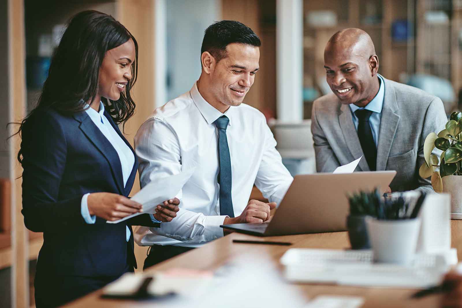 Group of professional accountants looking at a computer