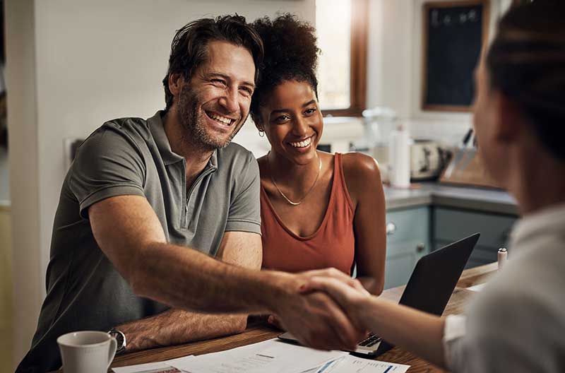 Happy couple speaking with their experienced accountant