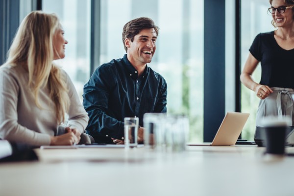 Man laughing during a payroll tax filing meeting