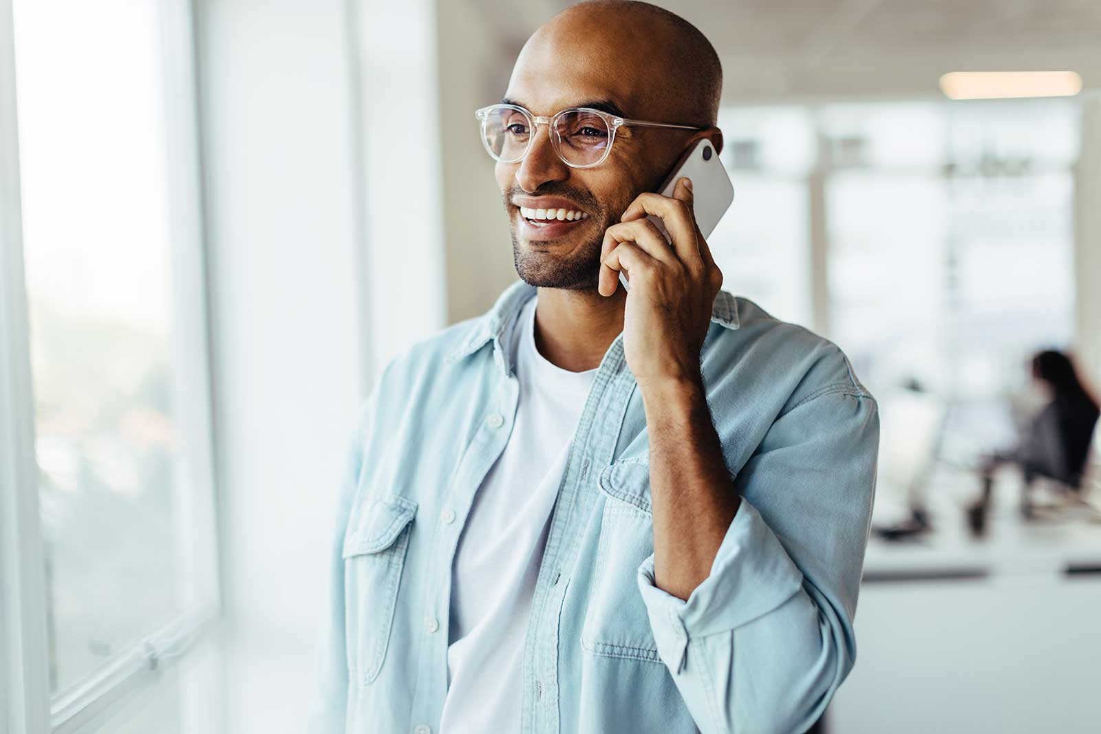 Man on phone with financial firm inquiring about their accounting and tax solutions