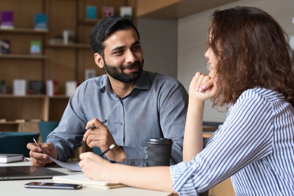 Man providing payroll reporting services to woman