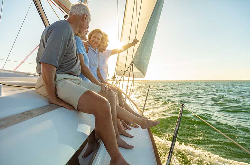 Senior on a boat after happy after acquiring retirement planning services