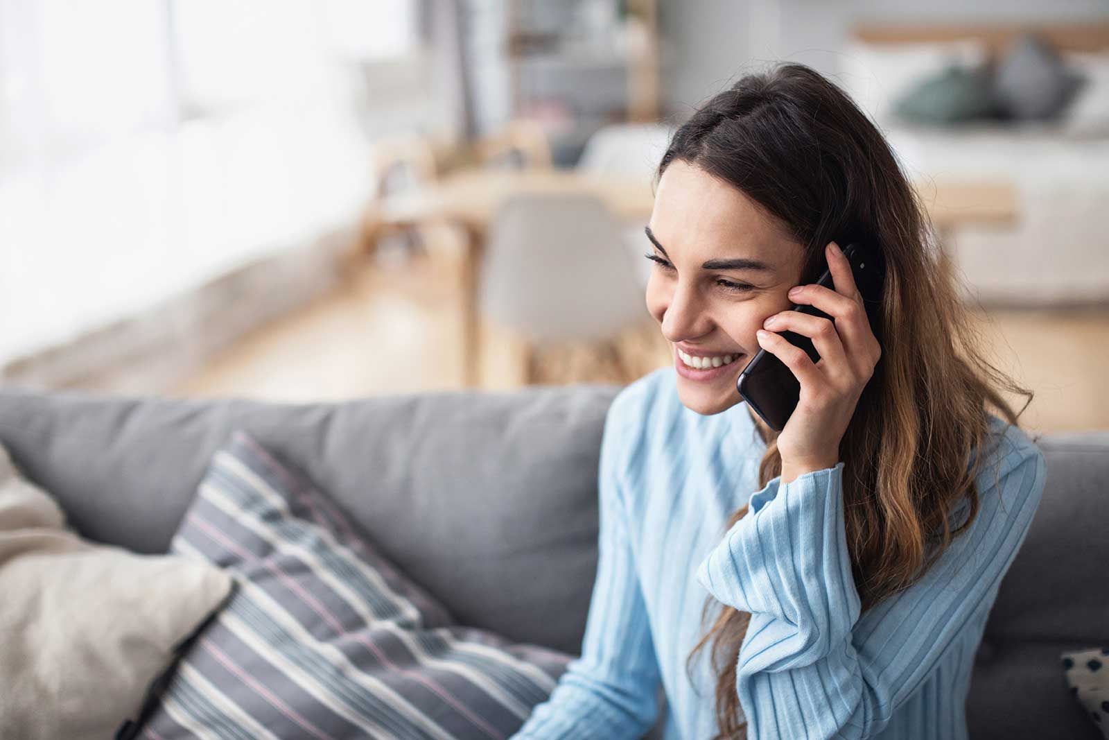 Young woman on the phone scheduling a consultation with a wealth management firm