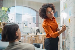 black businesswoman leads business meeting with managers