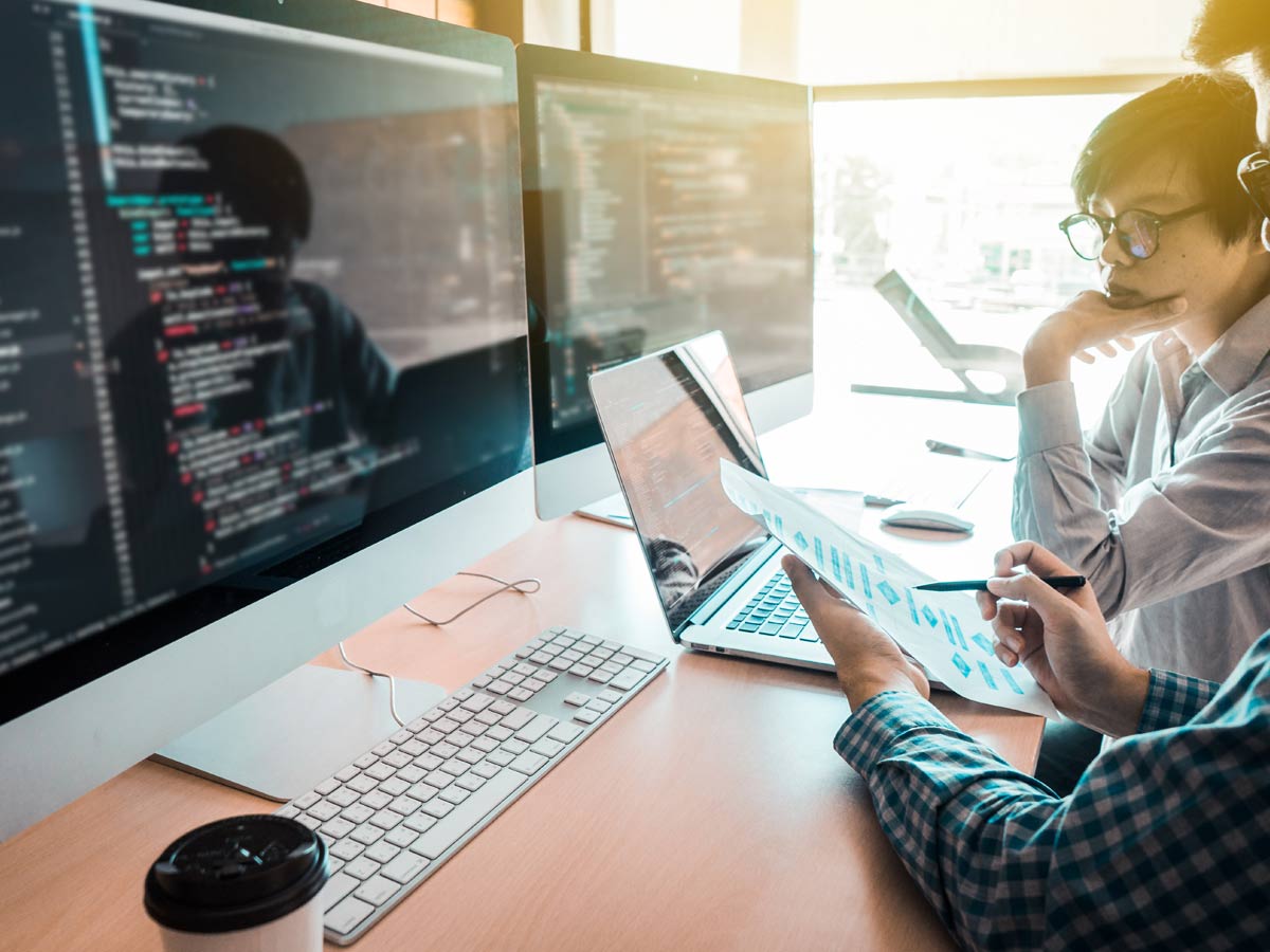 two men who work together at office getting caught up on plan