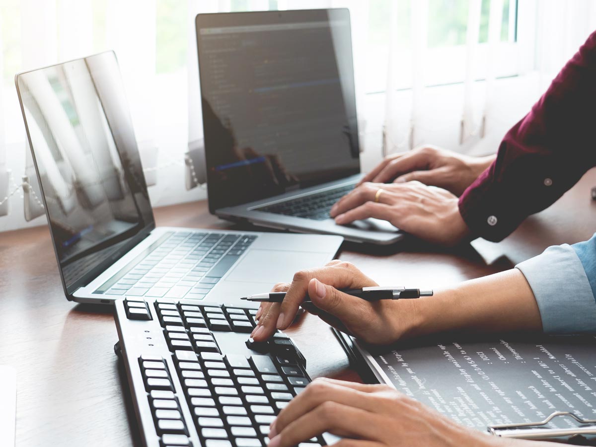 two people on a tech team working in office