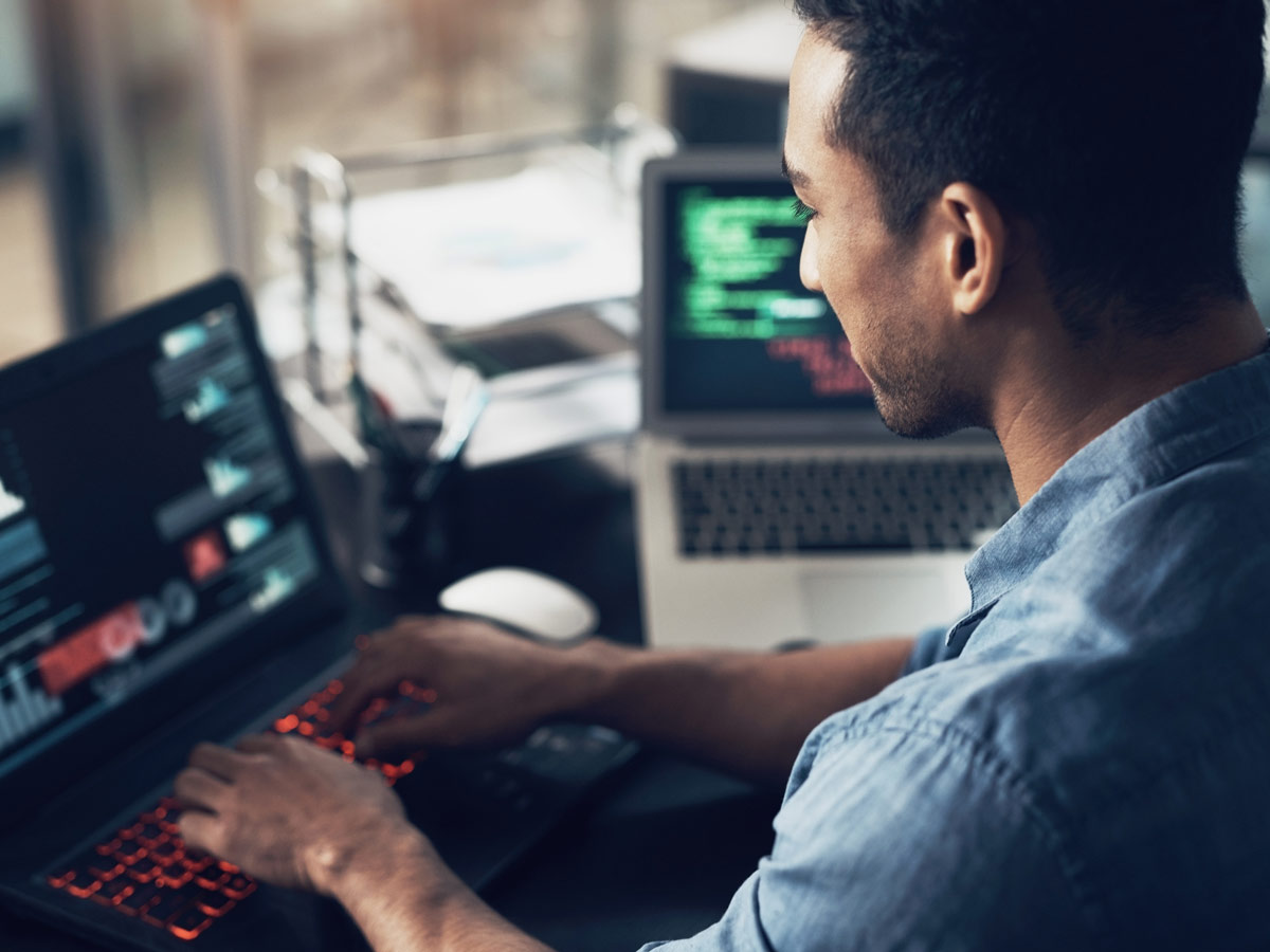 man looking a his technology on desktop