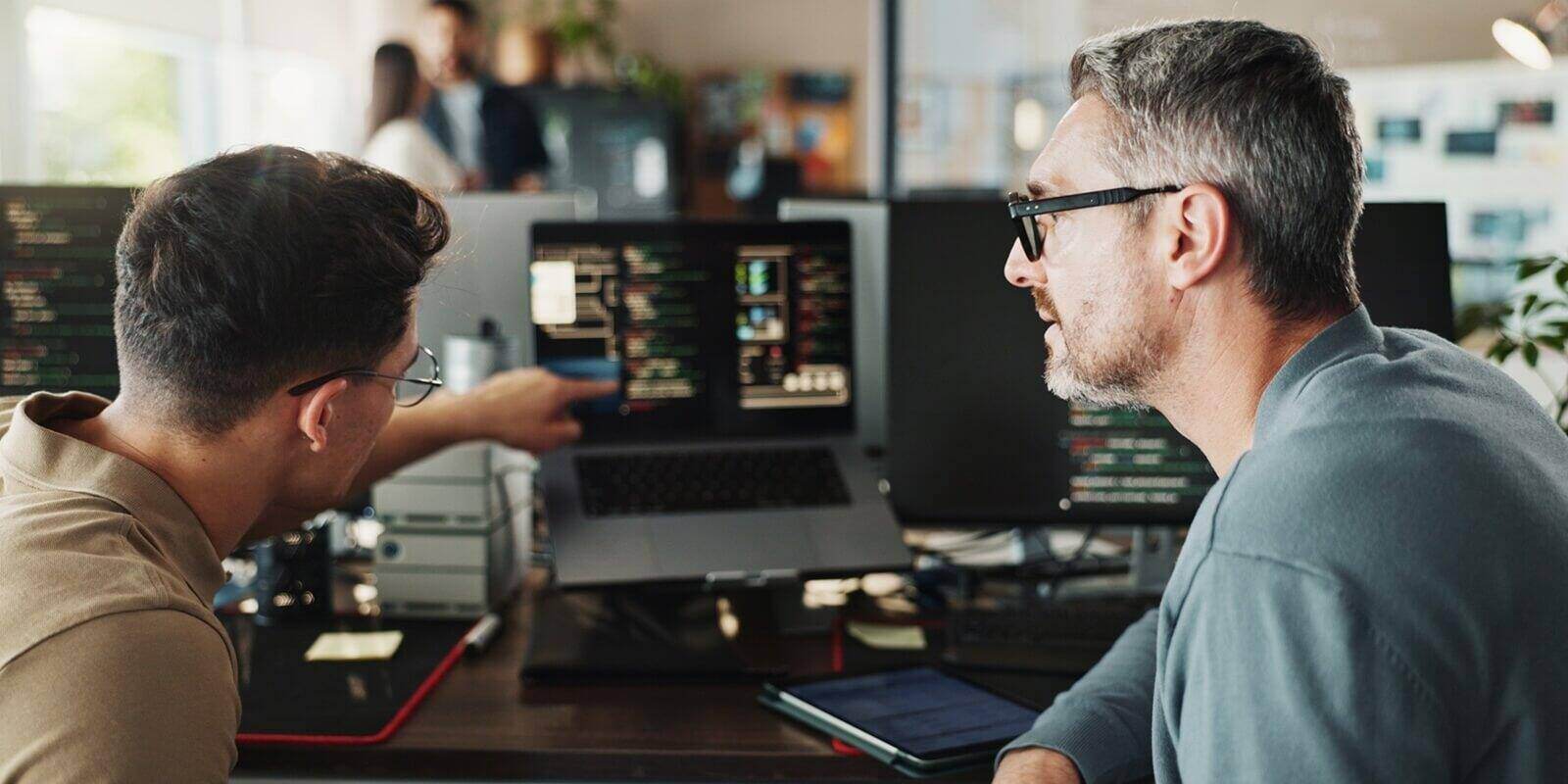 developer and coding support on computer screen in office for testing web application and troubleshooting