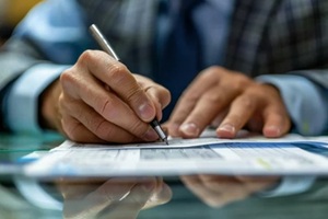 man signing salary cheque of an employee